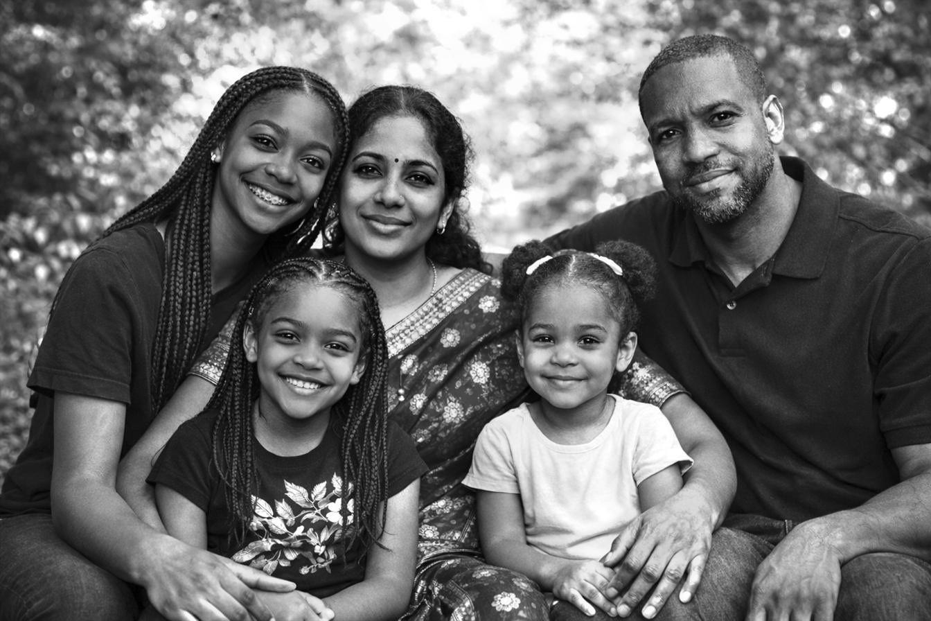 A family photographed together, three generations, smiling.